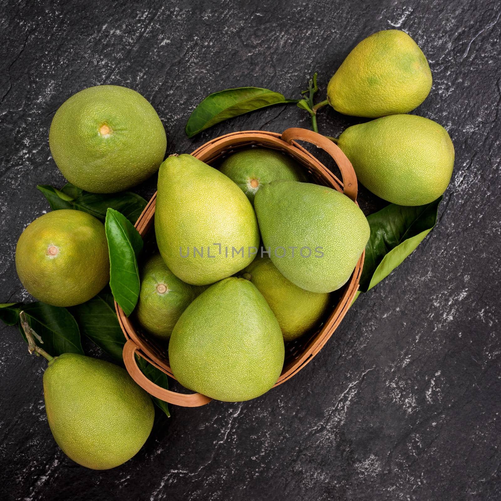 Fresh pomelo, pummelo, grapefruit, shaddock on black background, fruit for Mid-autumn festival, top view, flat lay.