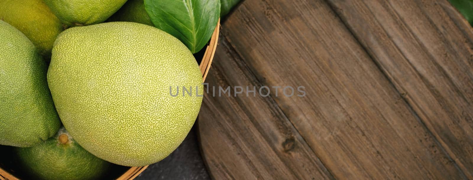 Fresh pomelo, pummelo, grapefruit, shaddock on black background, fruit for Mid-autumn festival, top view, flat lay.