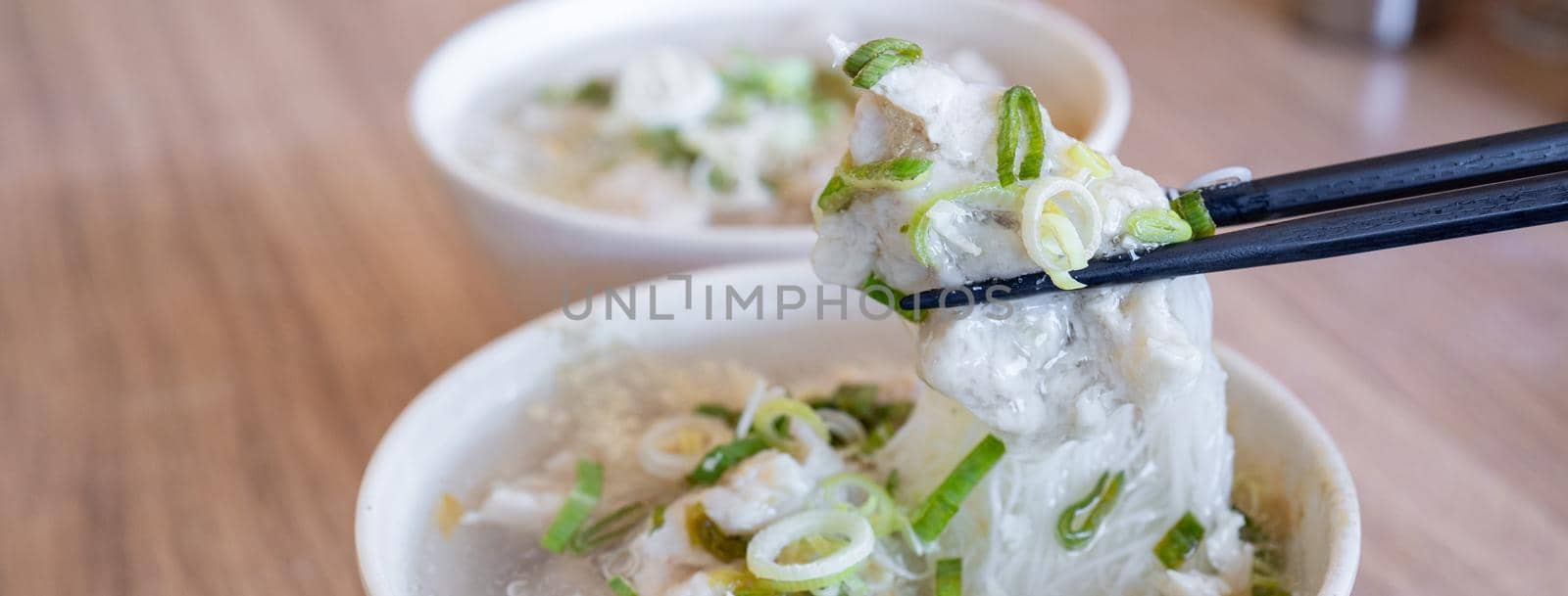 Delicious fish ball rice noodles in thick soup, common food in Tainan, Taiwan, Asia, Asian Taiwanese street delicacy cuisine, close up, lifestyle.