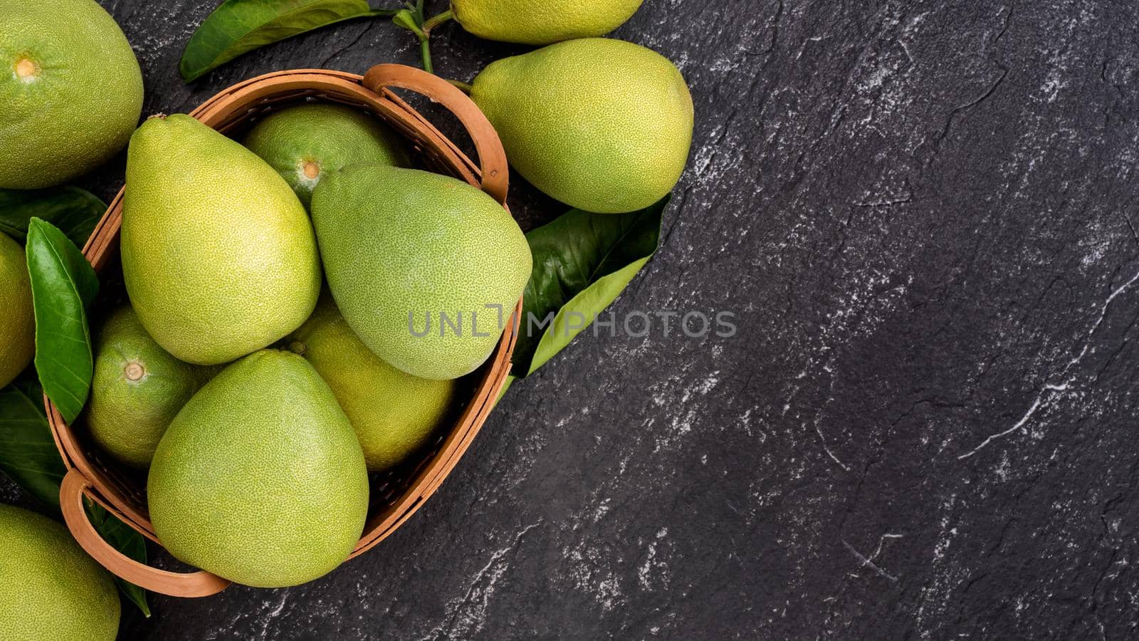 Fresh pomelo, pummelo, grapefruit, shaddock on black background, fruit for Mid-autumn festival, top view, flat lay.