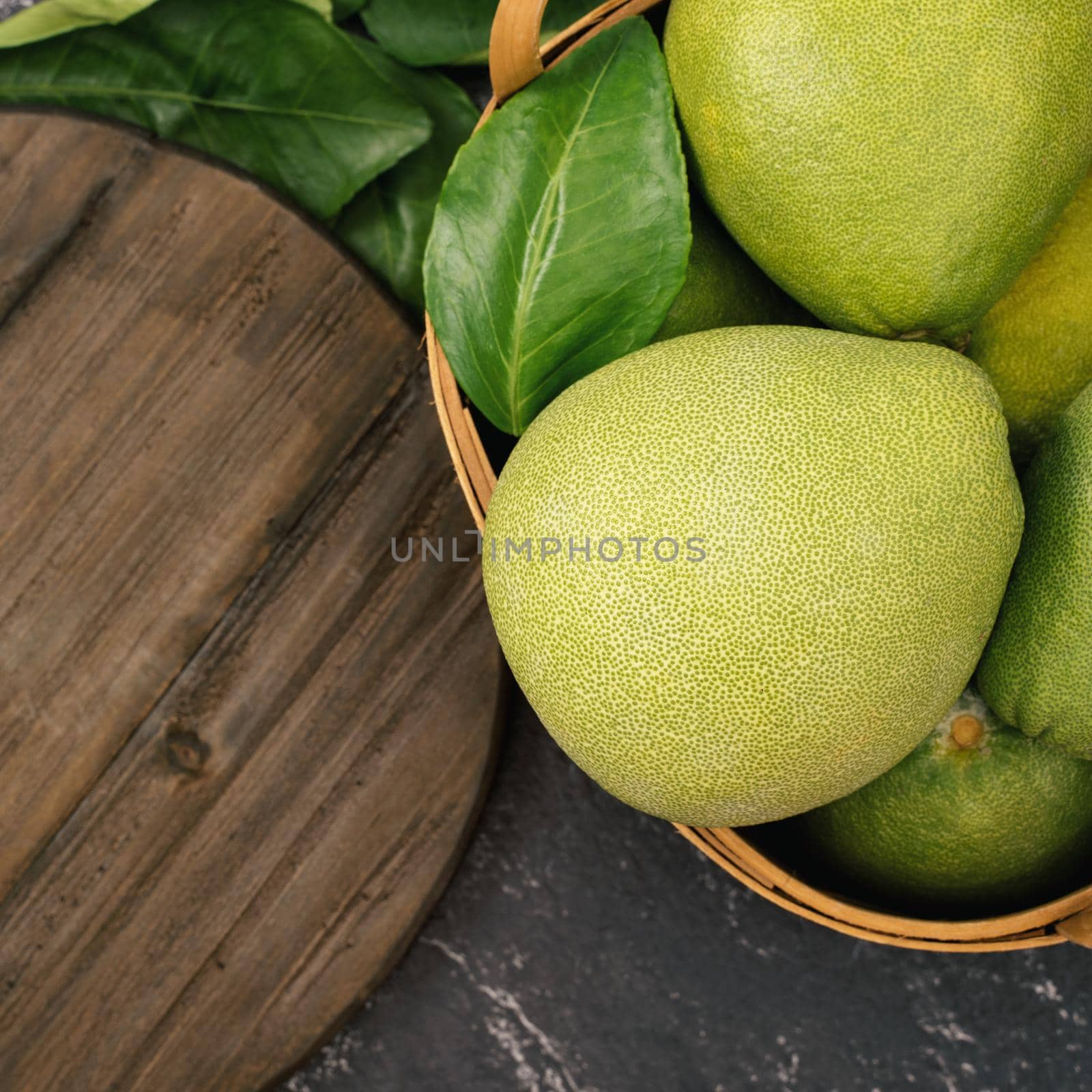 Fresh pomelo, pummelo, grapefruit, shaddock on black background, fruit for Mid-autumn festival, top view, flat lay.