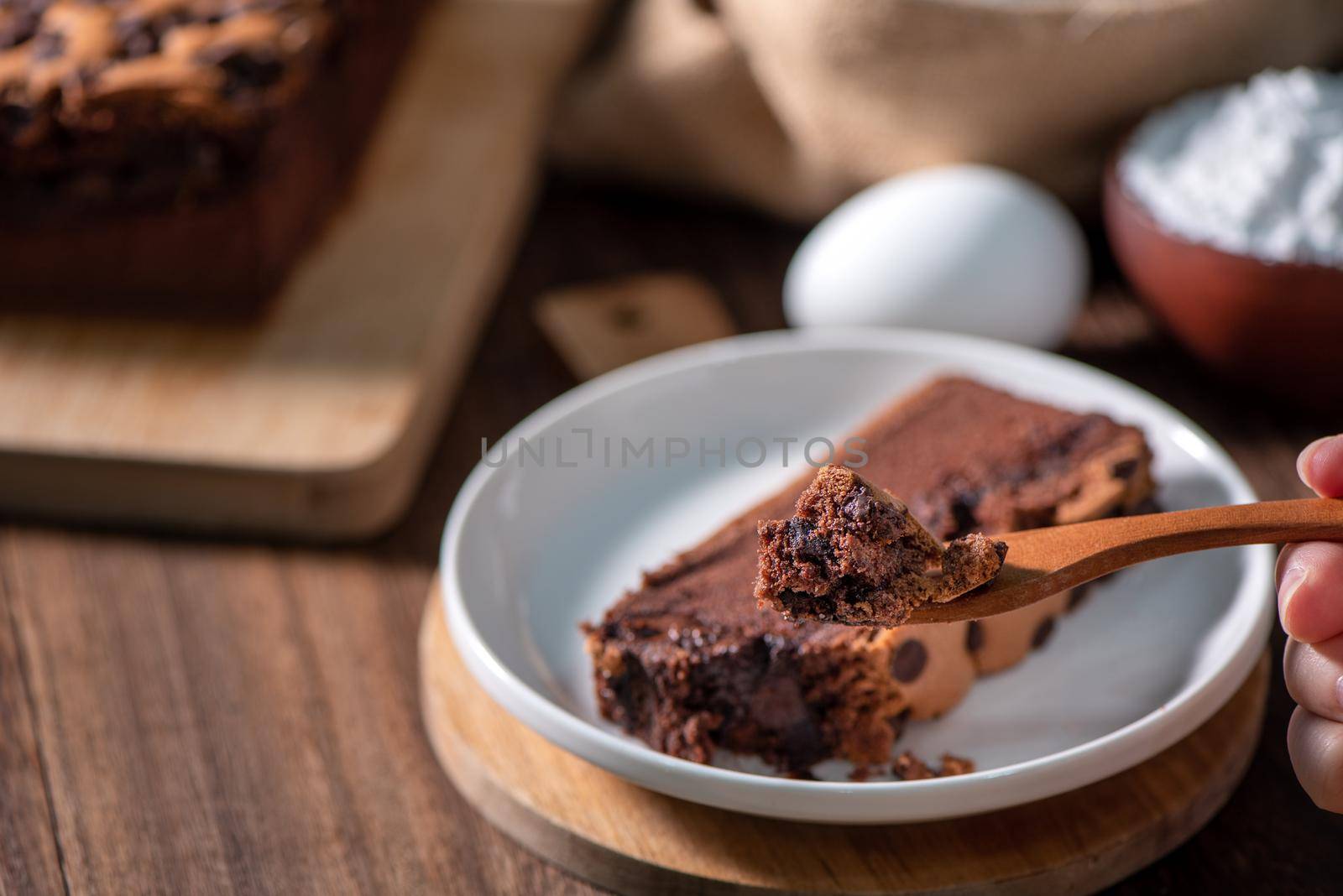 Chocolate flavor Taiwanese traditional sponge cake (Taiwanese castella kasutera) on a wooden tray background table with ingredients, close up.