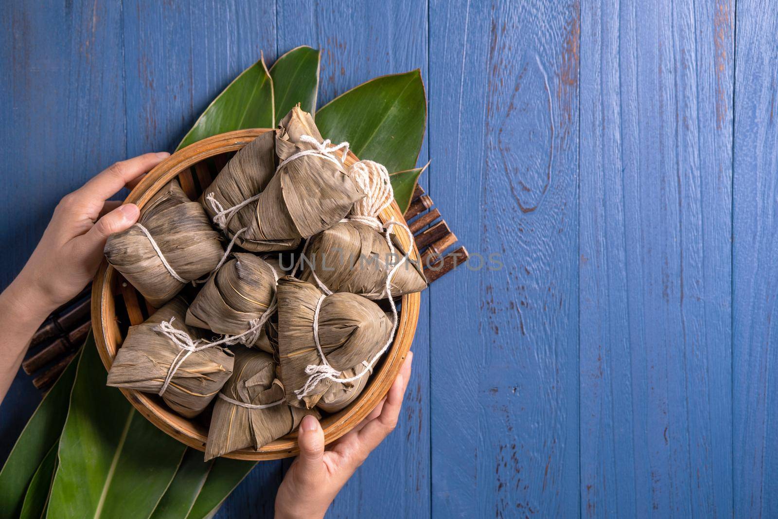 zongzi - Dragon Boat Festival concept Rice dumpling, traditional Chinese food on blue wooden background for Duanwu Festival, top view, flat lay design concept.