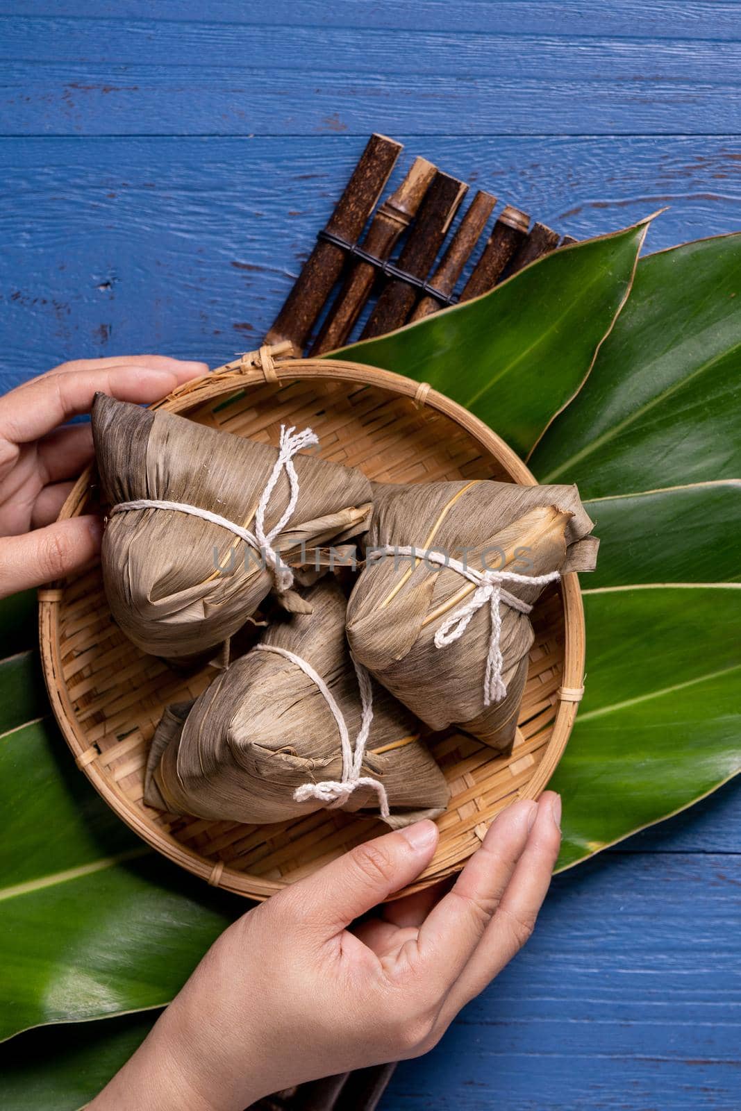 zongzi - Dragon Boat Festival concept Rice dumpling, traditional Chinese food on blue wooden background for Duanwu Festival, top view, flat lay design concept.