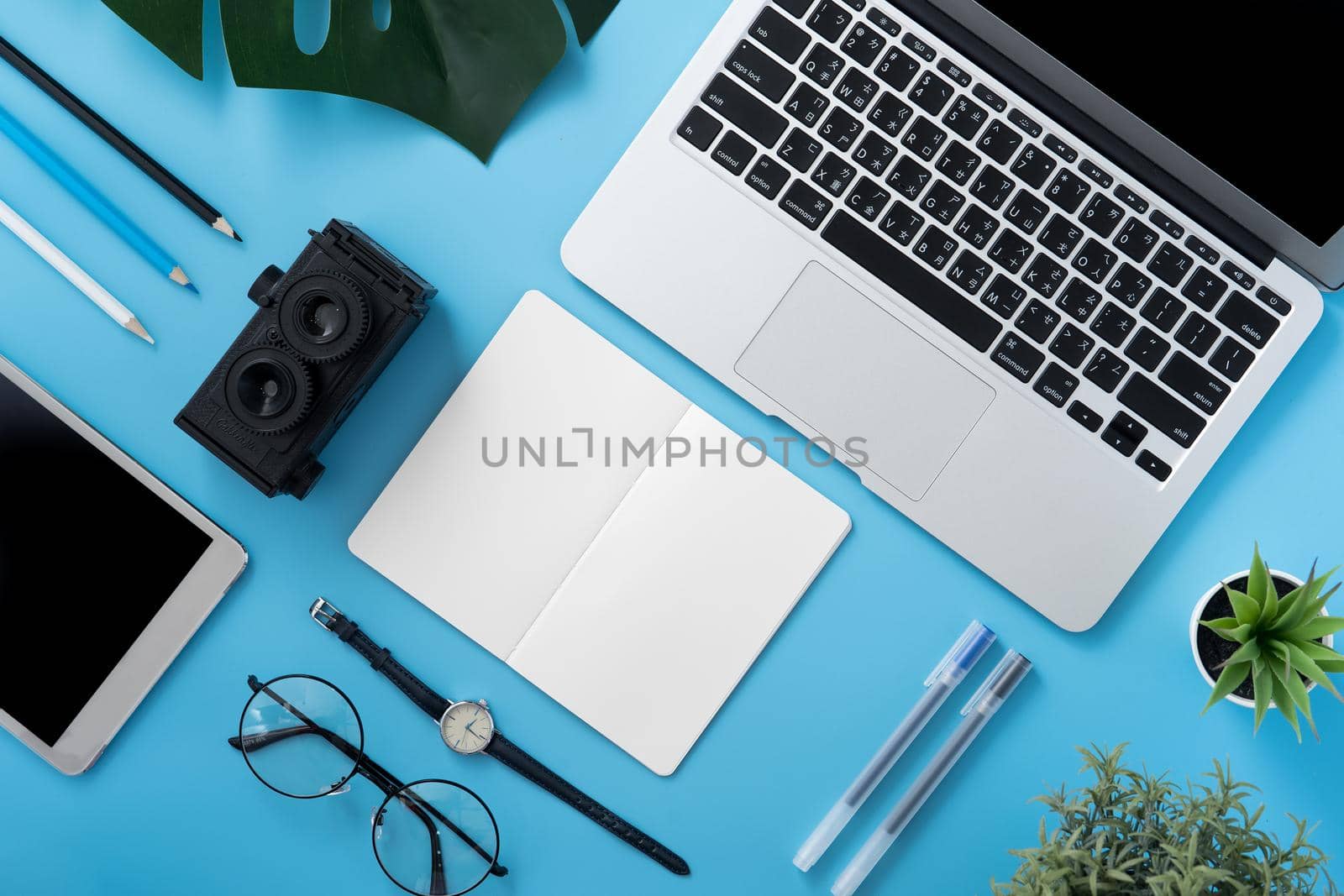 Concept of stylized home office table with fashion accessories, minimal interior, workspace design, close up, flat lay, copy space, top view, mockup