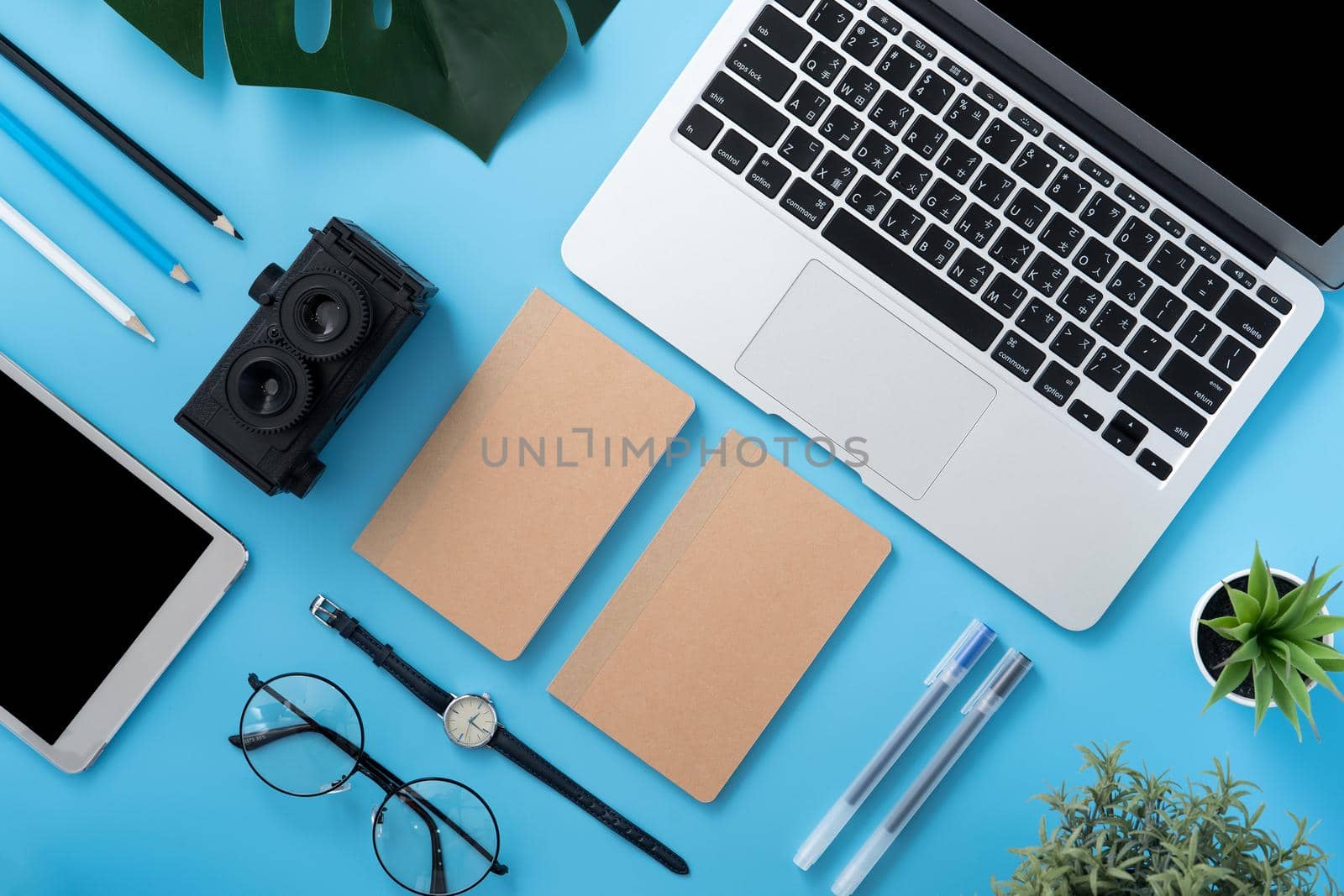 Concept of stylized home office table with fashion accessories, minimal interior, workspace design, close up, flat lay, copy space, top view, mockup
