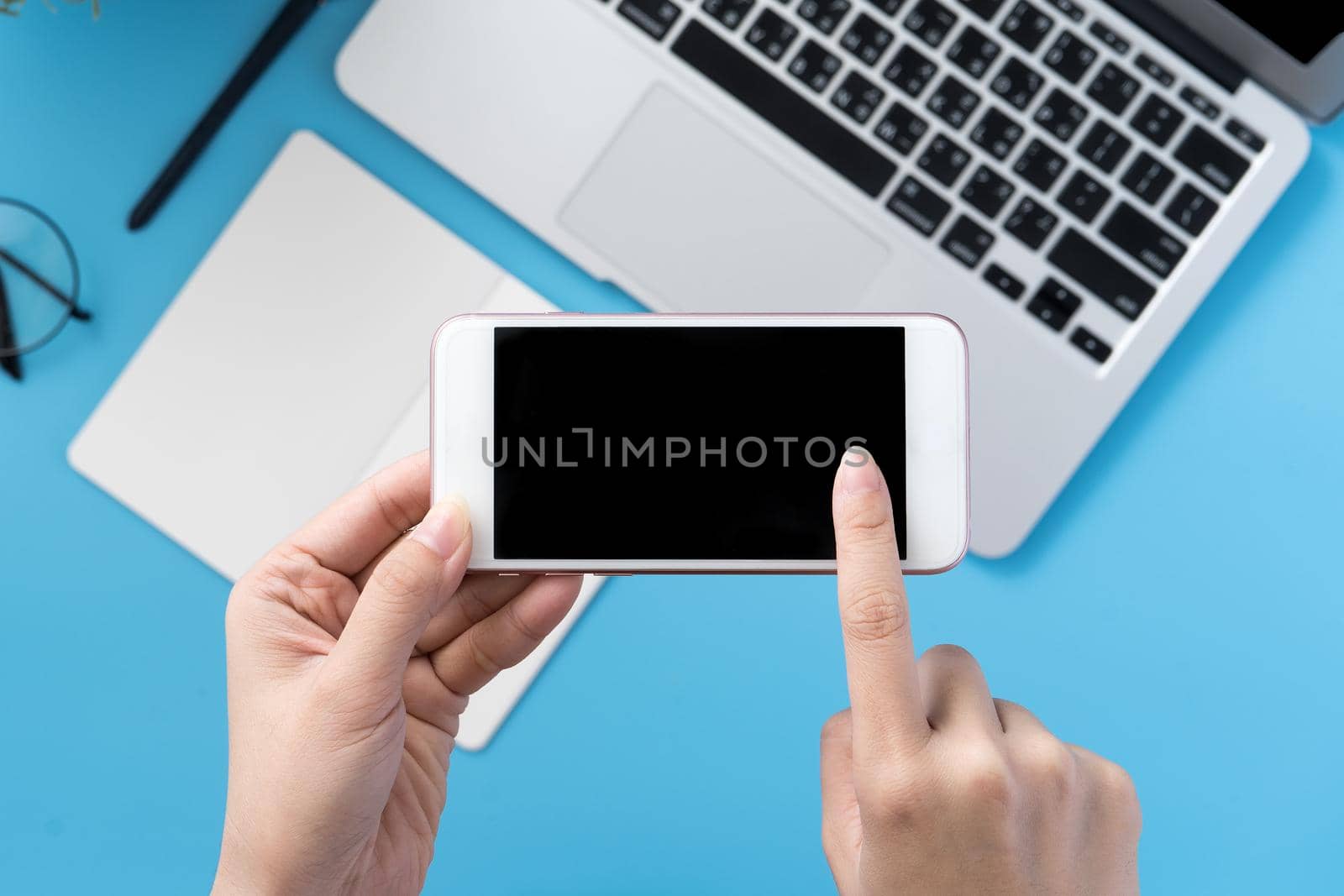 Social network connecting office table concept with fashion accessories, minimal interior with a woman holding smartphone, top view, flat lay, mockup, copy space