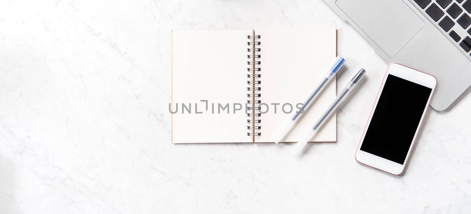 Stylized marble office working desk with smartphone, laptop, glasses and coffee, workspace design, mock up, topview, flatlay, copyspace, closeup