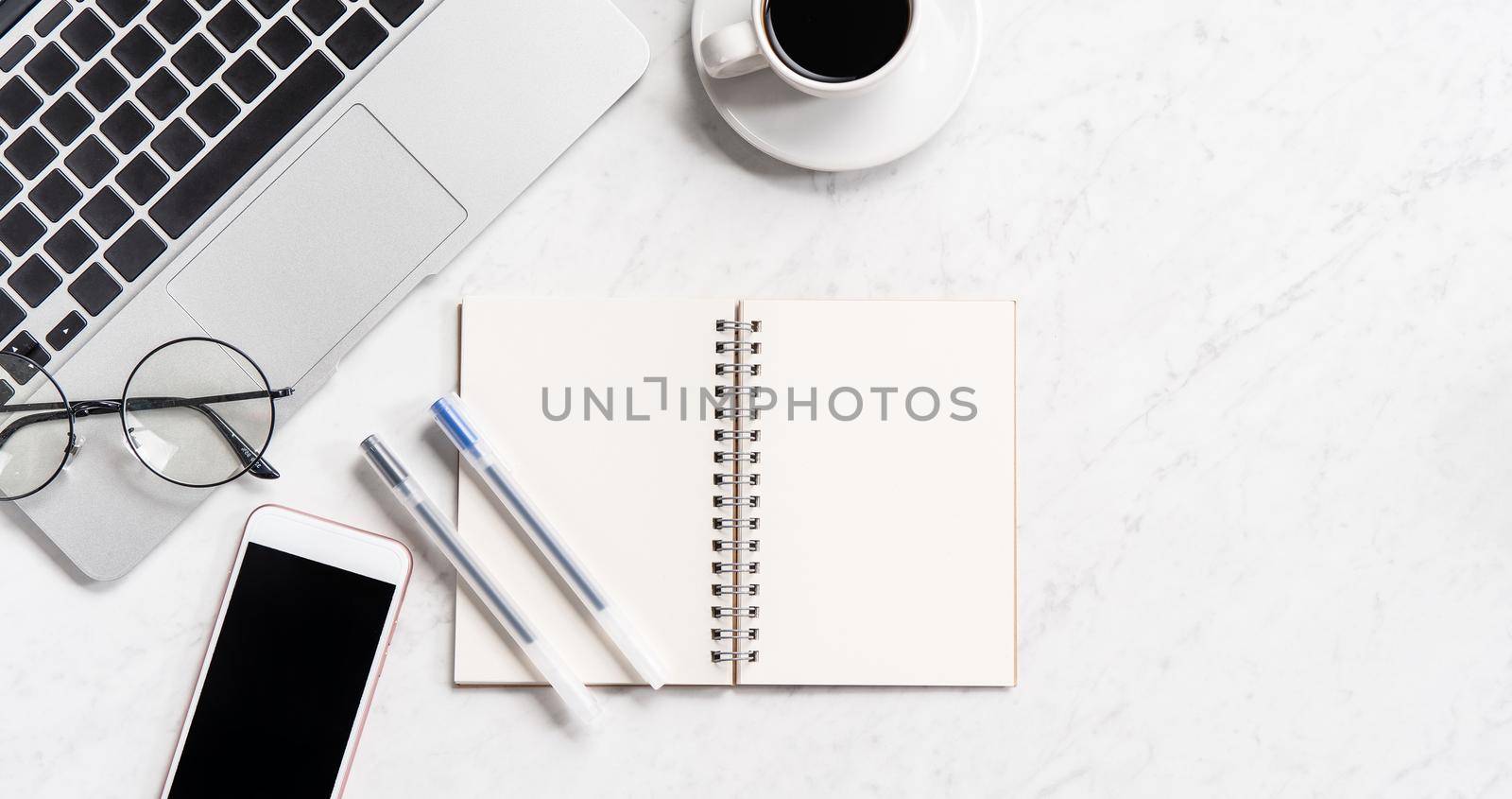 Stylized marble office working desk with smartphone, laptop, glasses and coffee, workspace design, mock up, topview, flatlay, copyspace, closeup by ROMIXIMAGE