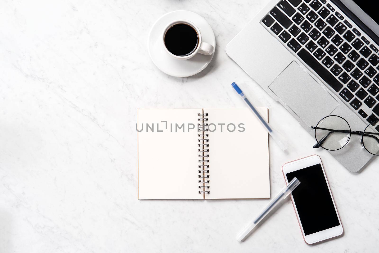 Stylized marble office working desk with smartphone, laptop, glasses and coffee, workspace design, mock up, topview, flatlay, copyspace, closeup by ROMIXIMAGE