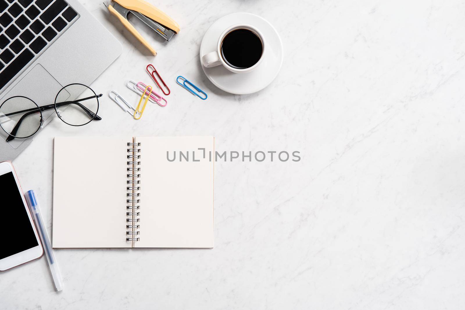 Stylized marble office working desk with smartphone, laptop, glasses and coffee, workspace design, mock up, topview, flatlay, copyspace, closeup by ROMIXIMAGE