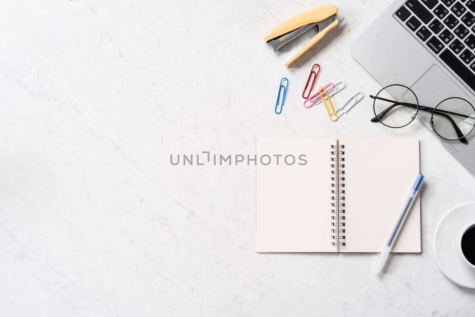 Stylized marble office working desk with smartphone, laptop, glasses and coffee, workspace design, mock up, topview, flatlay, copyspace, closeup