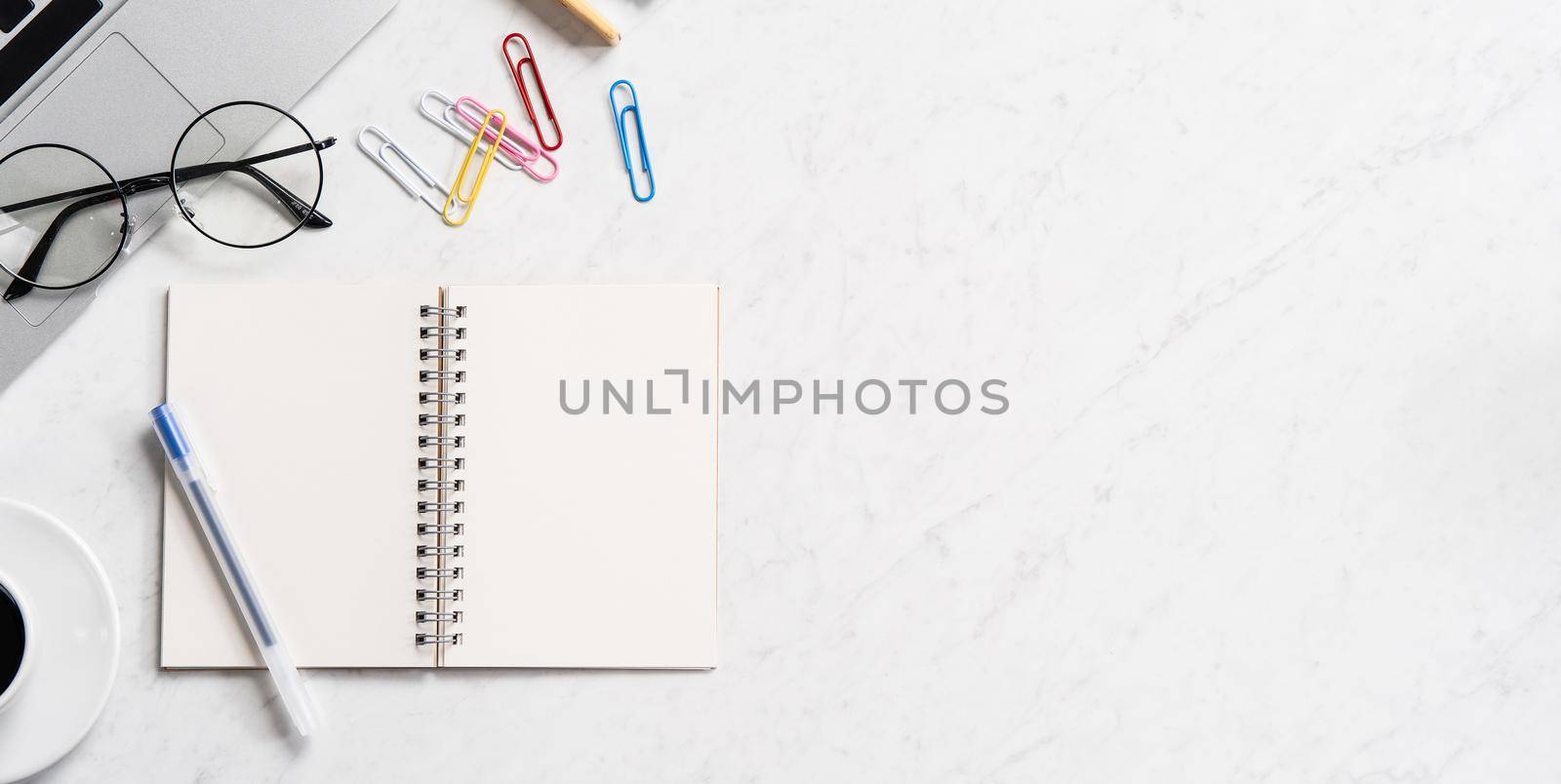 Stylized marble office working desk with smartphone, laptop, glasses and coffee, workspace design, mock up, topview, flatlay, copyspace, closeup