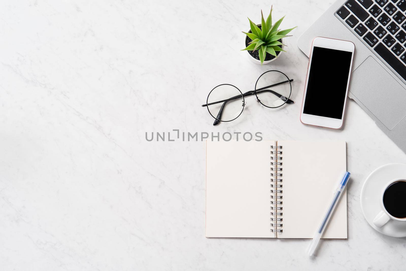 Stylized marble office working desk with smartphone, laptop, glasses and coffee, workspace design, mock up, topview, flatlay, copyspace, closeup by ROMIXIMAGE