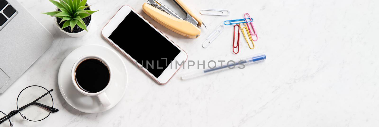 Stylized marble office working desk with smartphone, laptop, glasses and coffee, workspace design, mock up, topview, flatlay, copyspace, closeup by ROMIXIMAGE