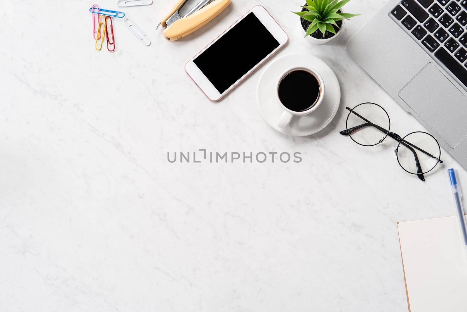 Stylized marble office working desk with smartphone, laptop, glasses and coffee, workspace design, mock up, topview, flatlay, copyspace, closeup by ROMIXIMAGE