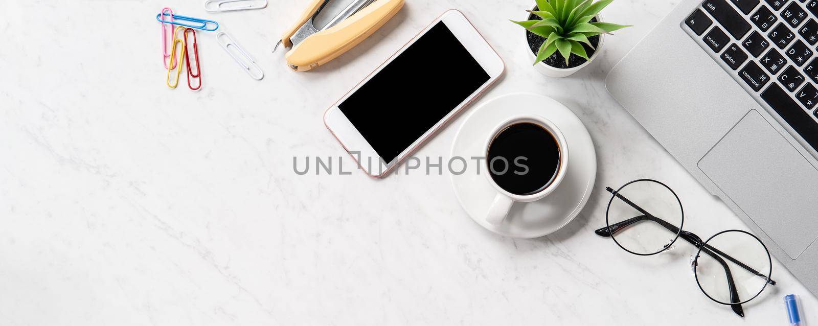 Stylized marble office working desk with smartphone, laptop, glasses and coffee, workspace design, mock up, topview, flatlay, copyspace, closeup by ROMIXIMAGE