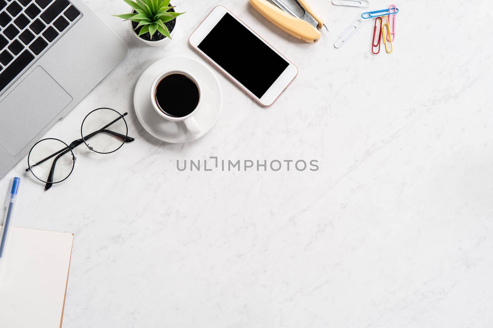 Stylized marble office working desk with smartphone, laptop, glasses and coffee, workspace design, mock up, topview, flatlay, copyspace, closeup by ROMIXIMAGE