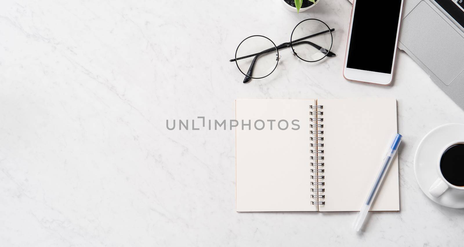 Stylized marble office working desk with smartphone, laptop, glasses and coffee, workspace design, mock up, topview, flatlay, copyspace, closeup by ROMIXIMAGE