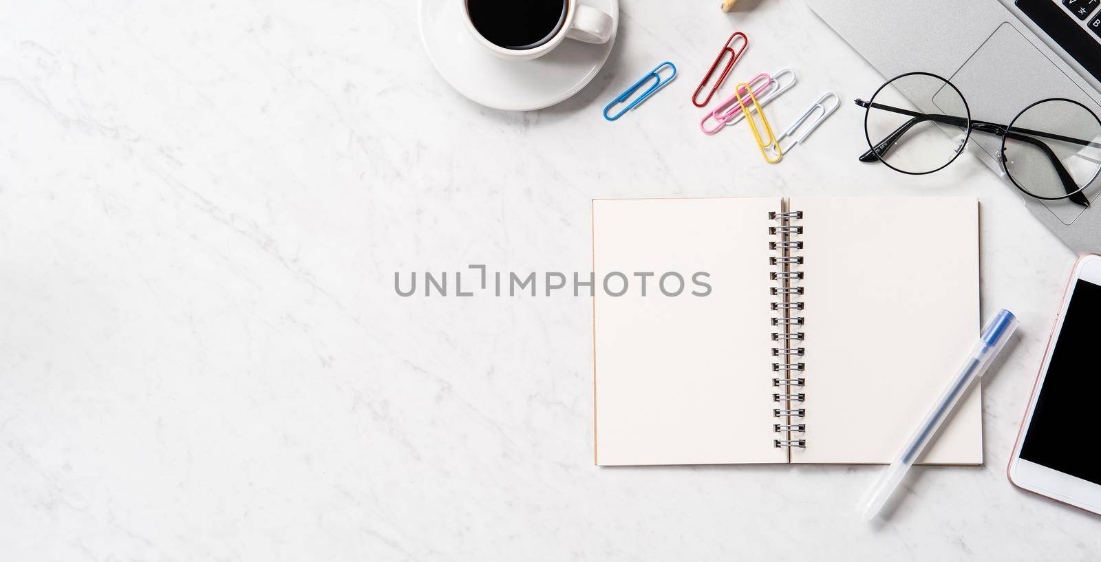 Stylized marble office working desk with smartphone, laptop, glasses and coffee, workspace design, mock up, topview, flatlay, copyspace, closeup by ROMIXIMAGE