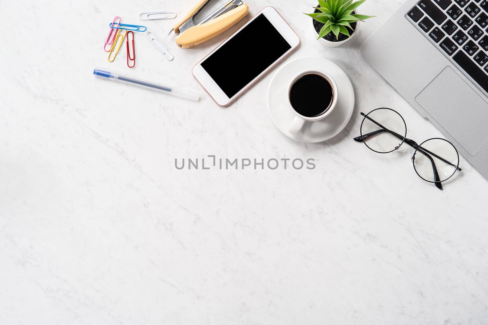 Stylized marble office working desk with smartphone, laptop, glasses and coffee, workspace design, mock up, topview, flatlay, copyspace, closeup by ROMIXIMAGE