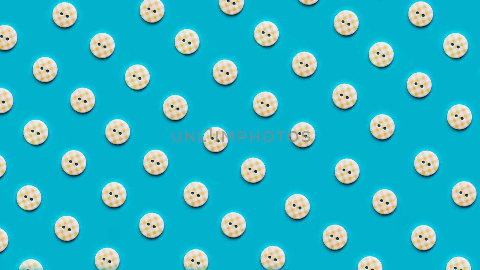 Top view of buttons in rows arranged on blue background