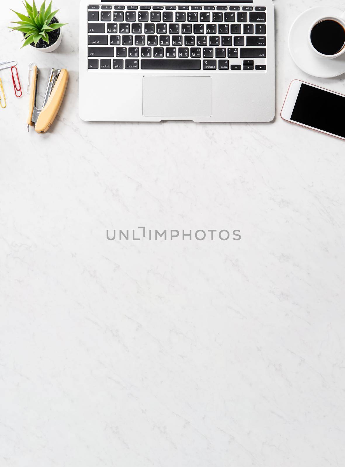 Stylized marble office working desk with smartphone, laptop, glasses and coffee, workspace design, mock up, topview, flatlay, copyspace, closeup