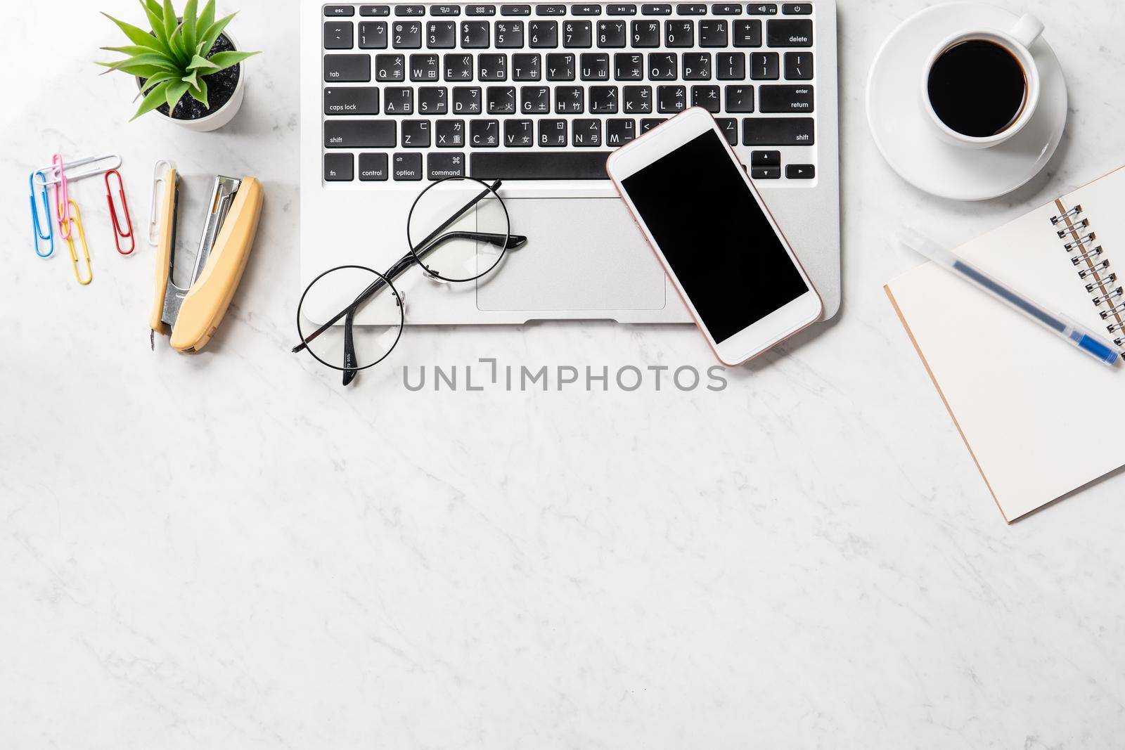 Stylized marble office working desk with smartphone, laptop, glasses and coffee, workspace design, mock up, topview, flatlay, copyspace, closeup by ROMIXIMAGE