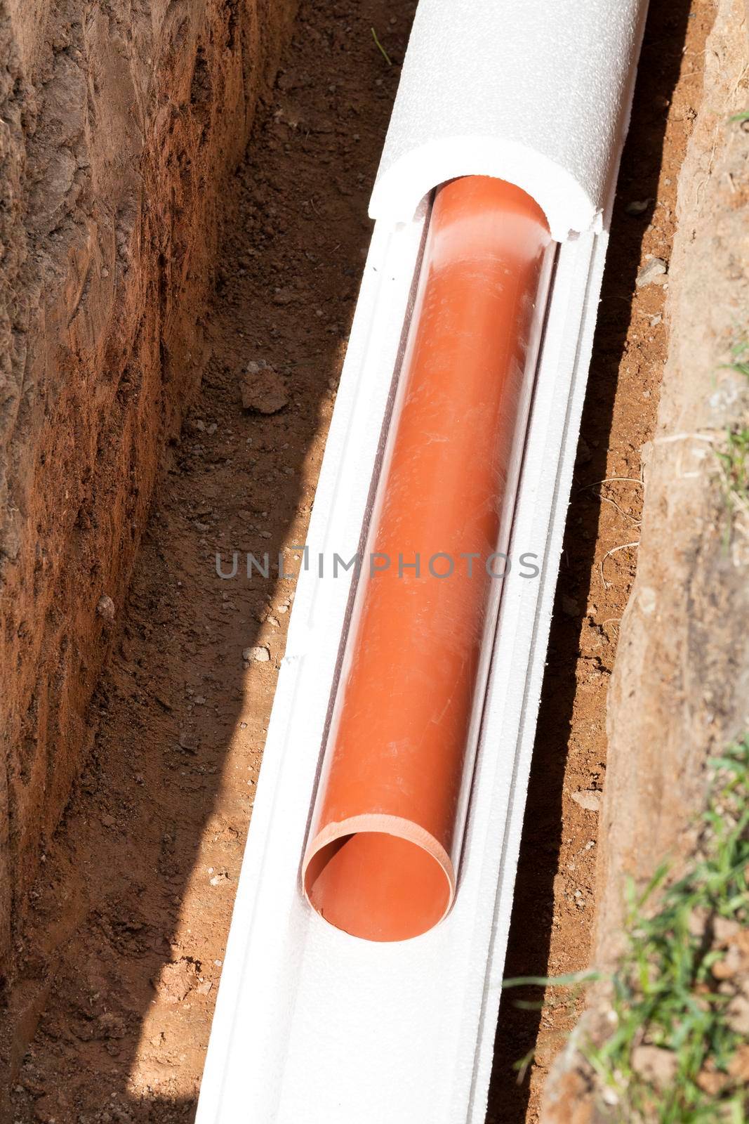 Installation of water main, sanitary sewer, storm drain systems, plastic pipes wrapped in insulation by Nobilior