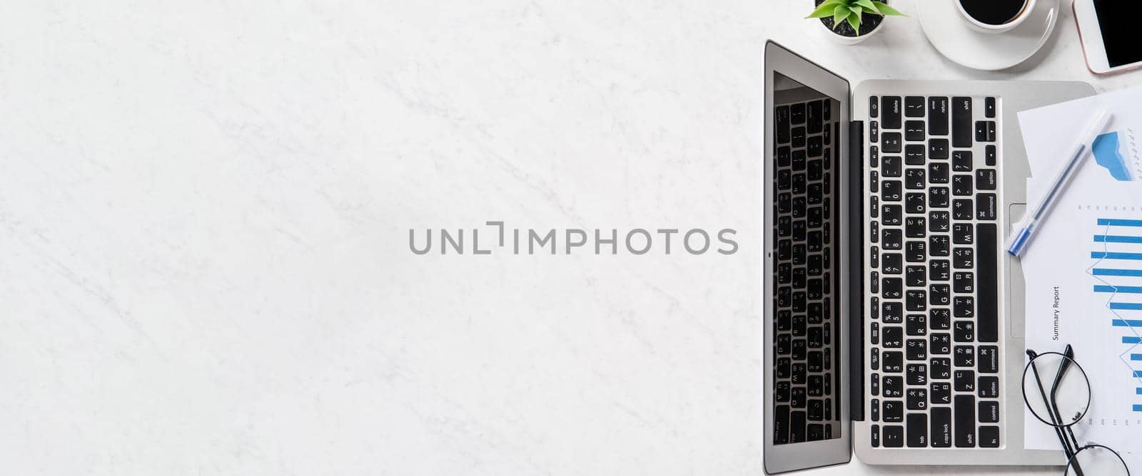 A woman is doing a online payment or shopping, mock up credit card and mobile phone on office desk isolated on beautiful fashion marble background, topview, flatlay, copyspace. by ROMIXIMAGE