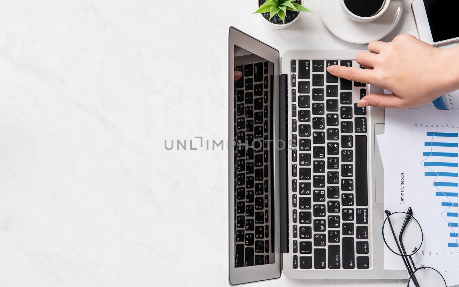 A woman is doing a online payment or shopping, mock up credit card and mobile phone on office desk isolated on beautiful fashion marble background, topview, flatlay, copyspace.