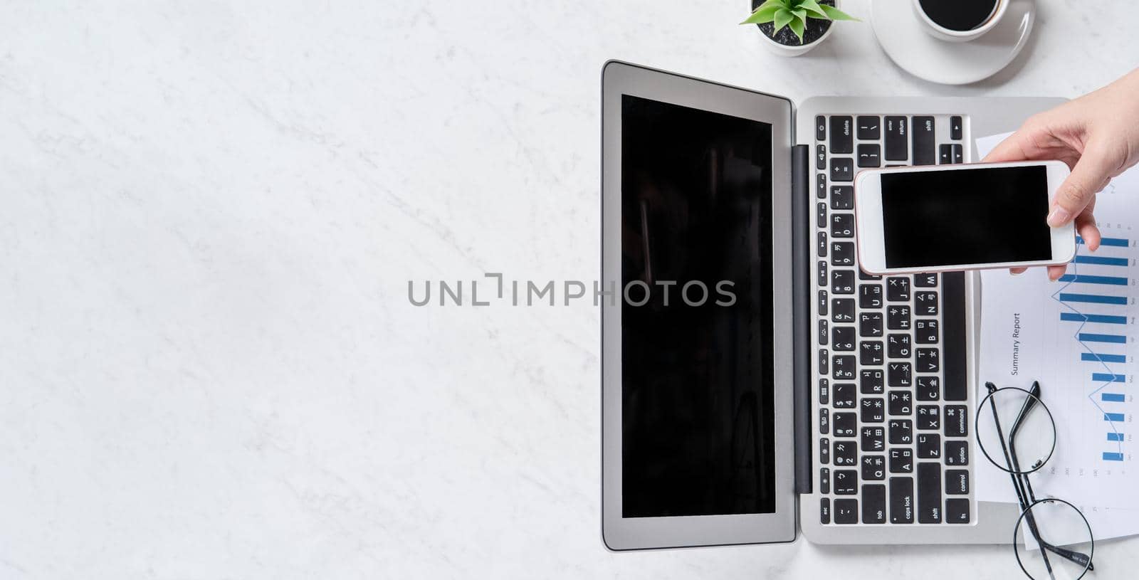 A woman is doing a online payment or shopping, mock up credit card and mobile phone on office desk isolated on beautiful fashion marble background, topview, flatlay, copyspace.