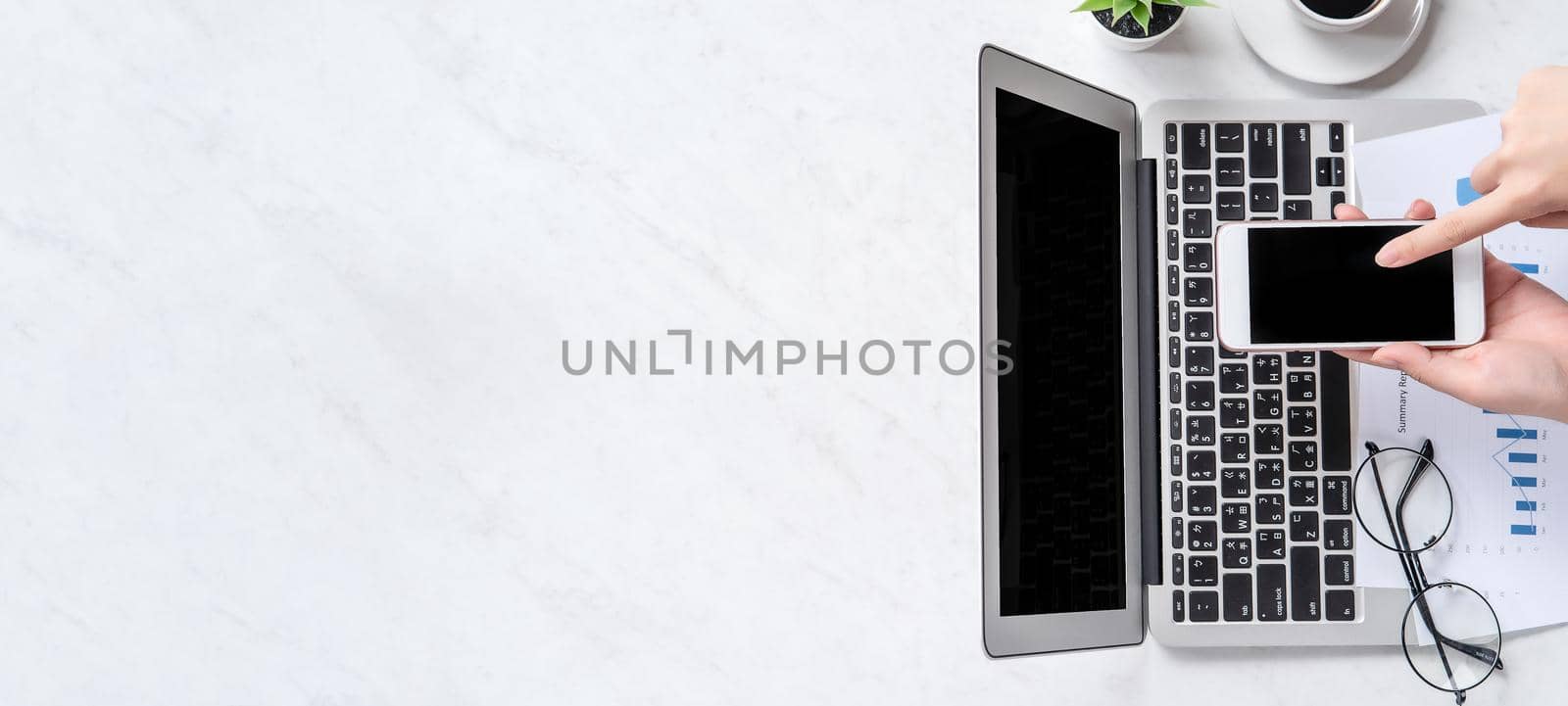 A woman is doing a online payment or shopping, mock up credit card and mobile phone on office desk isolated on beautiful fashion marble background, topview, flatlay, copyspace.