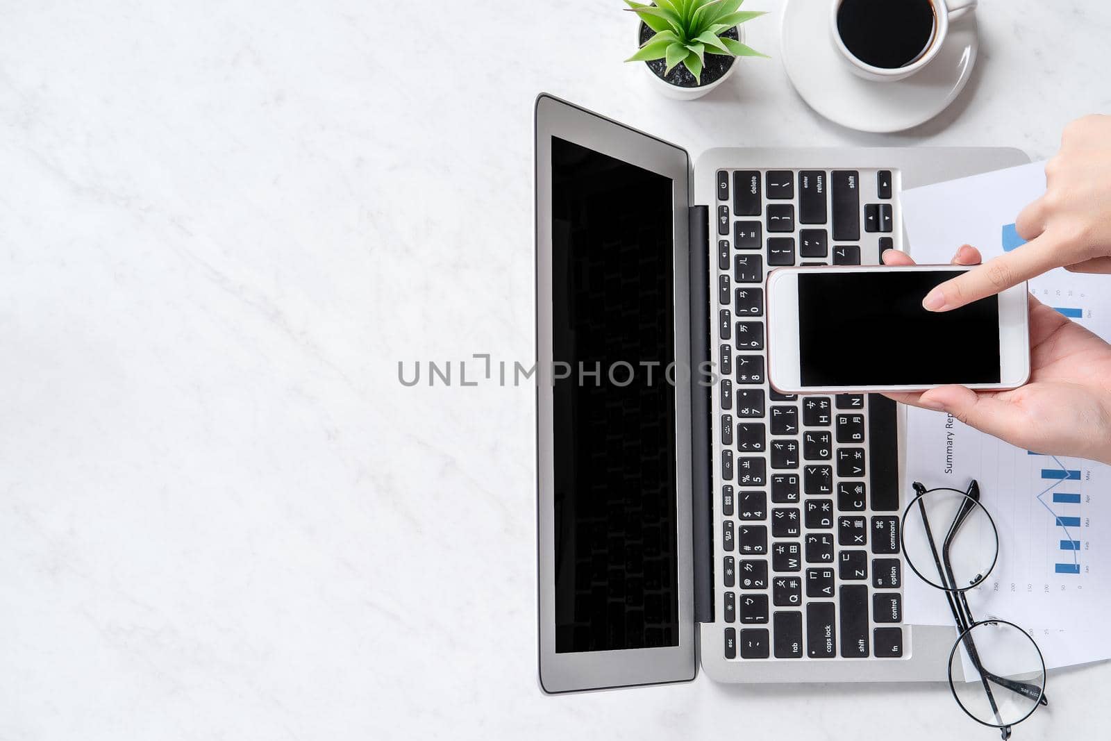 A woman is doing a online payment or shopping, mock up credit card and mobile phone on office desk isolated on beautiful fashion marble background, topview, flatlay, copyspace.