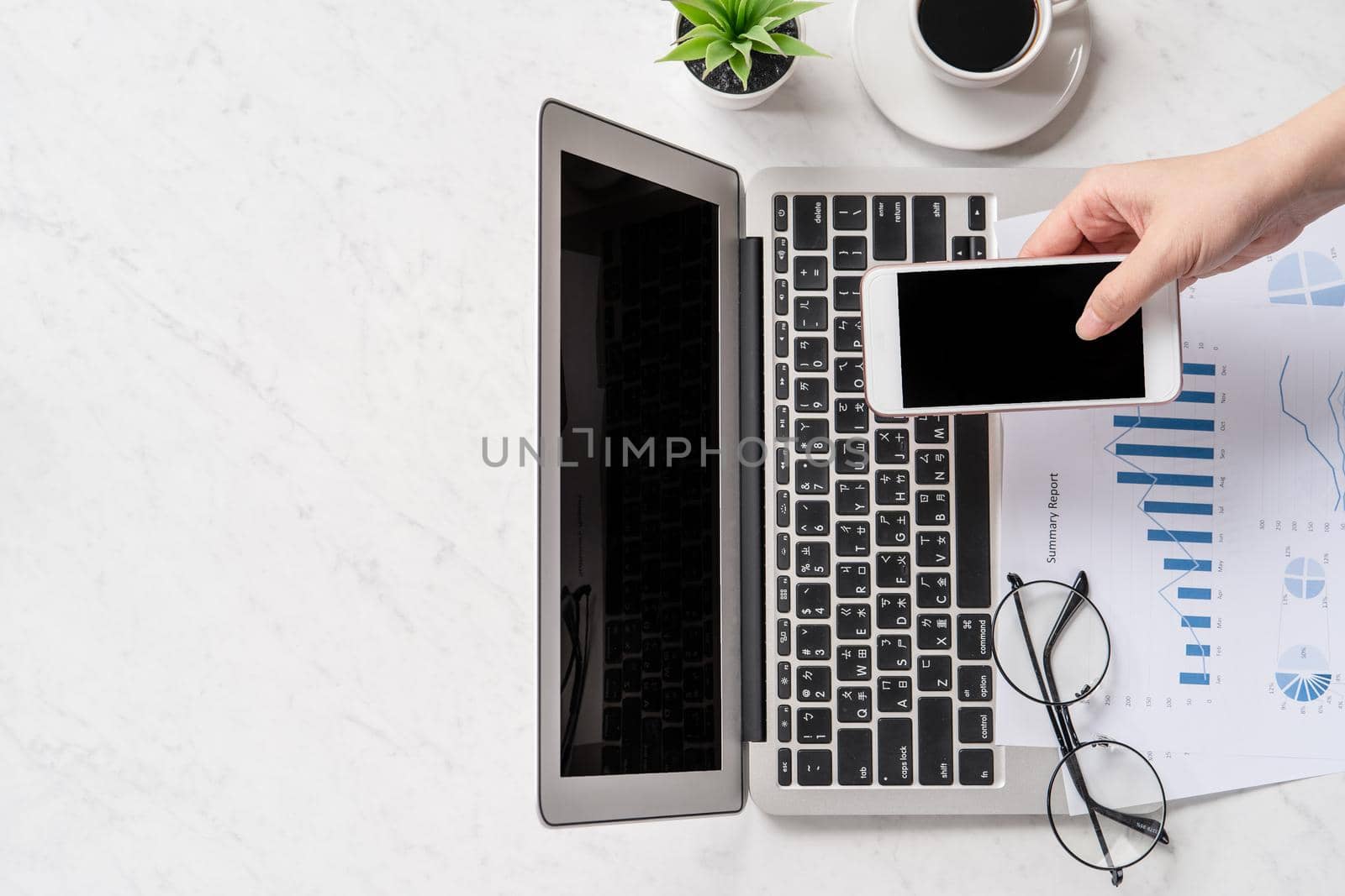 A woman is doing a online payment or shopping, mock up credit card and mobile phone on office desk isolated on beautiful fashion marble background, topview, flatlay, copyspace.