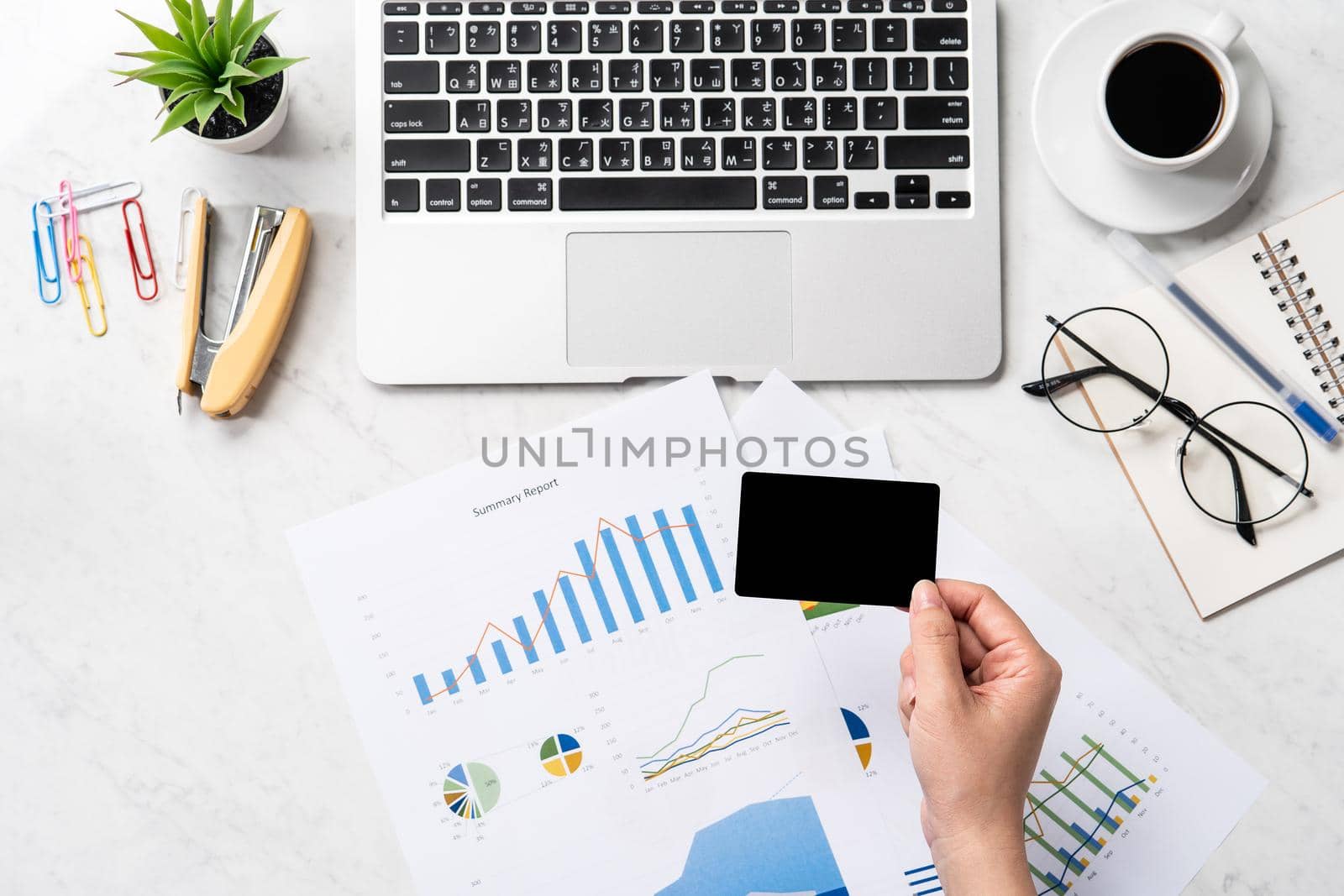 Online bill payment concept, a woman using mock up credit card and mobile cell phone on office desk isolated on beautiful fashion marble background, copy space, topview, flatlay, closeup