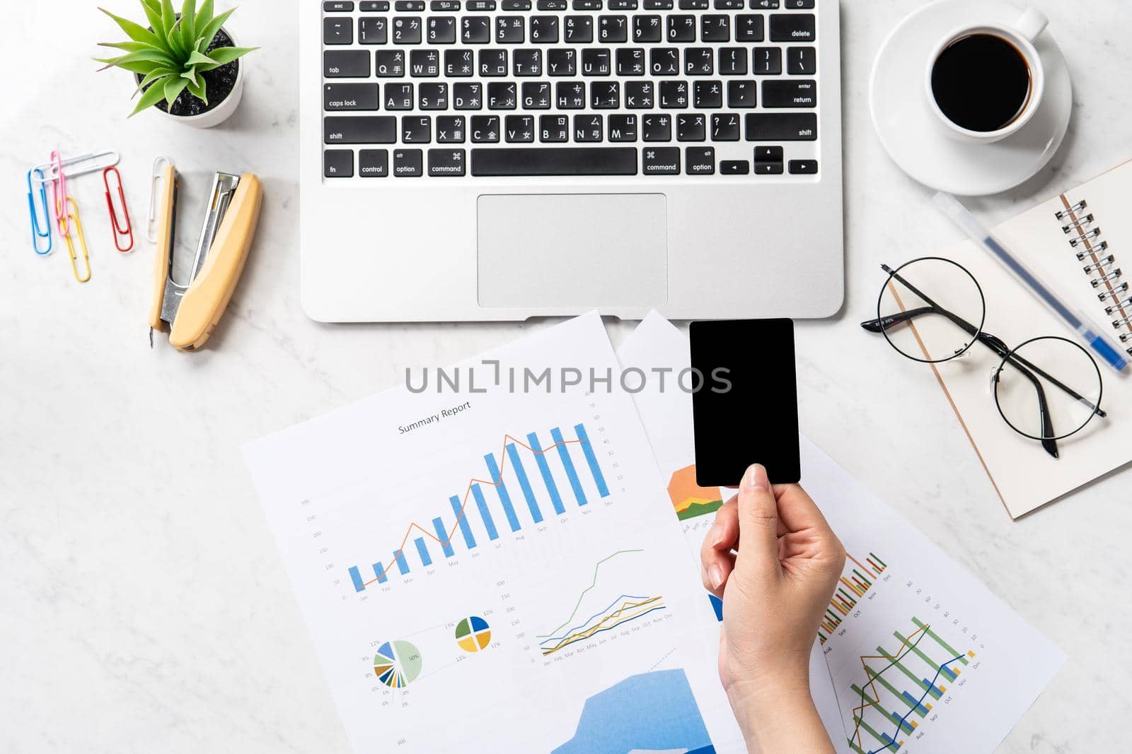 Online bill payment concept, a woman using mock up credit card and mobile cell phone on office desk isolated on beautiful fashion marble background, copy space, topview, flatlay, closeup