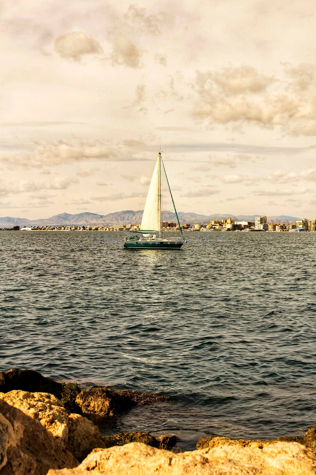 Sailboat entering the port of Santa Pola, Spain