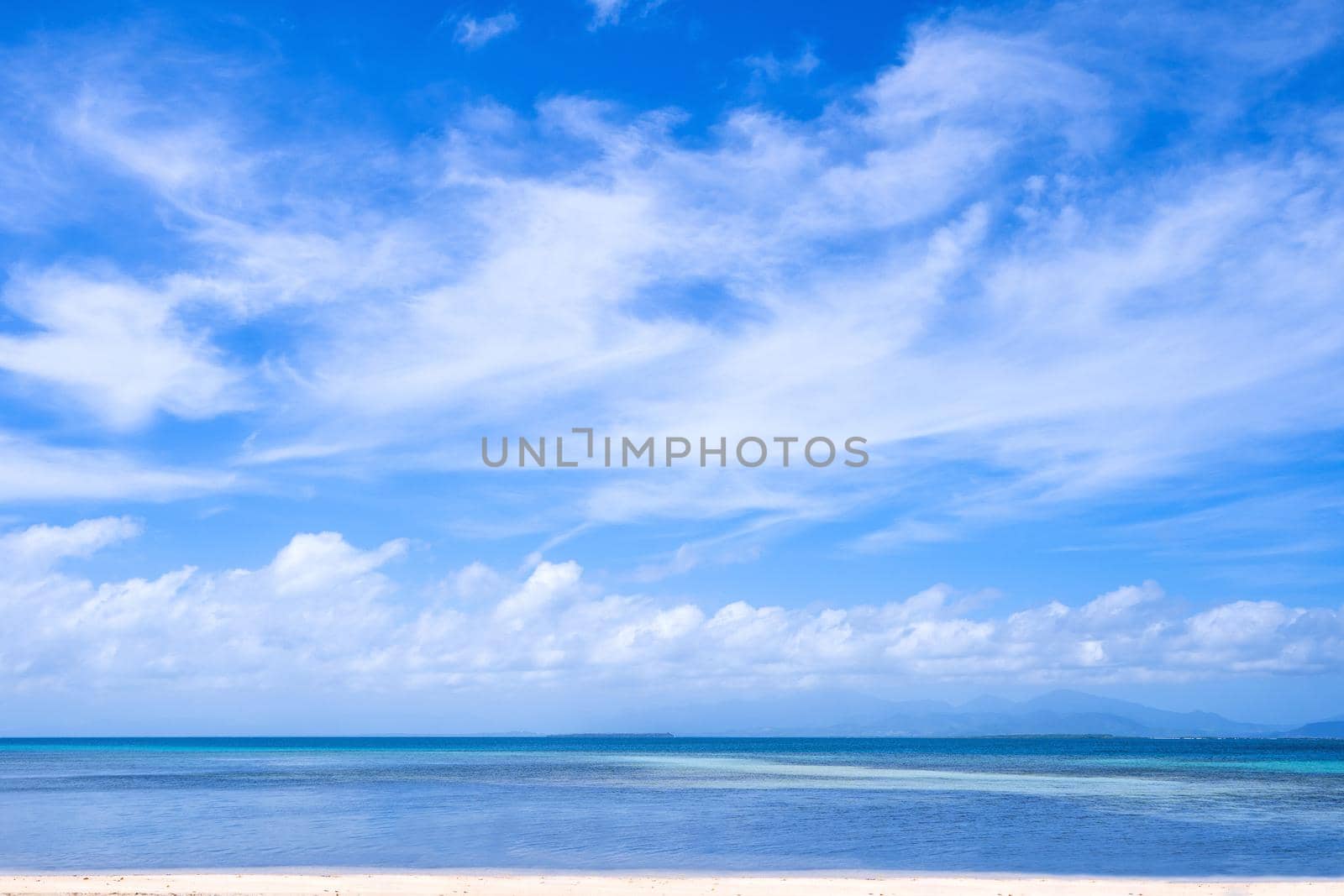 Beautiful ocean scene view isolated with light blue sky background, concept of vacation and sea travel, copy space