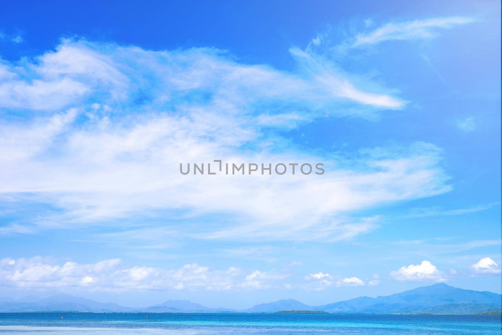 Beautiful ocean scene view isolated with light blue sky background, concept of vacation and sea travel, copy space