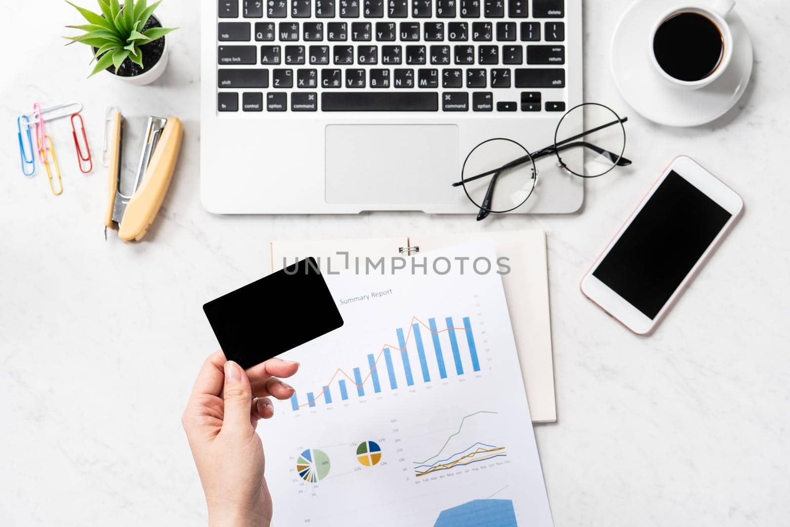 Online bill payment concept, a woman using mock up credit card and mobile cell phone on office desk isolated on beautiful fashion marble background, copy space, topview, flatlay, closeup