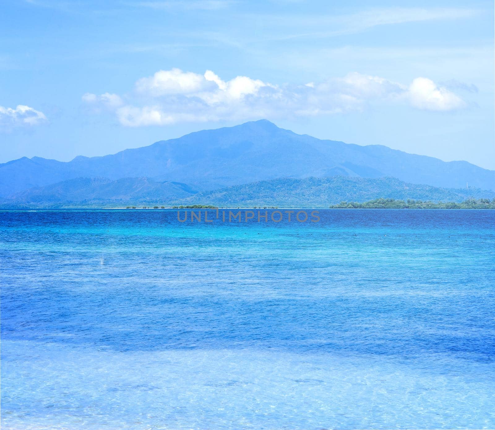 Beautiful ocean scene view isolated with light blue sky background, concept of vacation and sea travel, copy space