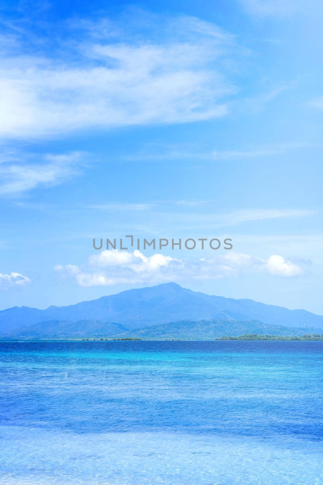 Beautiful ocean scene view isolated with light blue sky background, concept of vacation and sea travel, copy space
