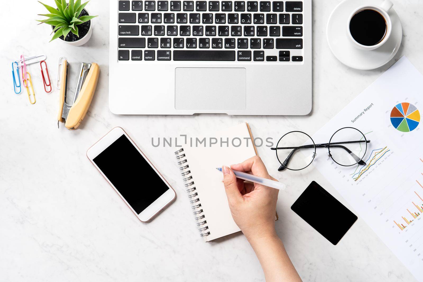 Concept of a woman is doing a accounting, mock up card and cellphone on office desk isolated on beautiful fashion marble background, copy space, top view, flat lay, closeup