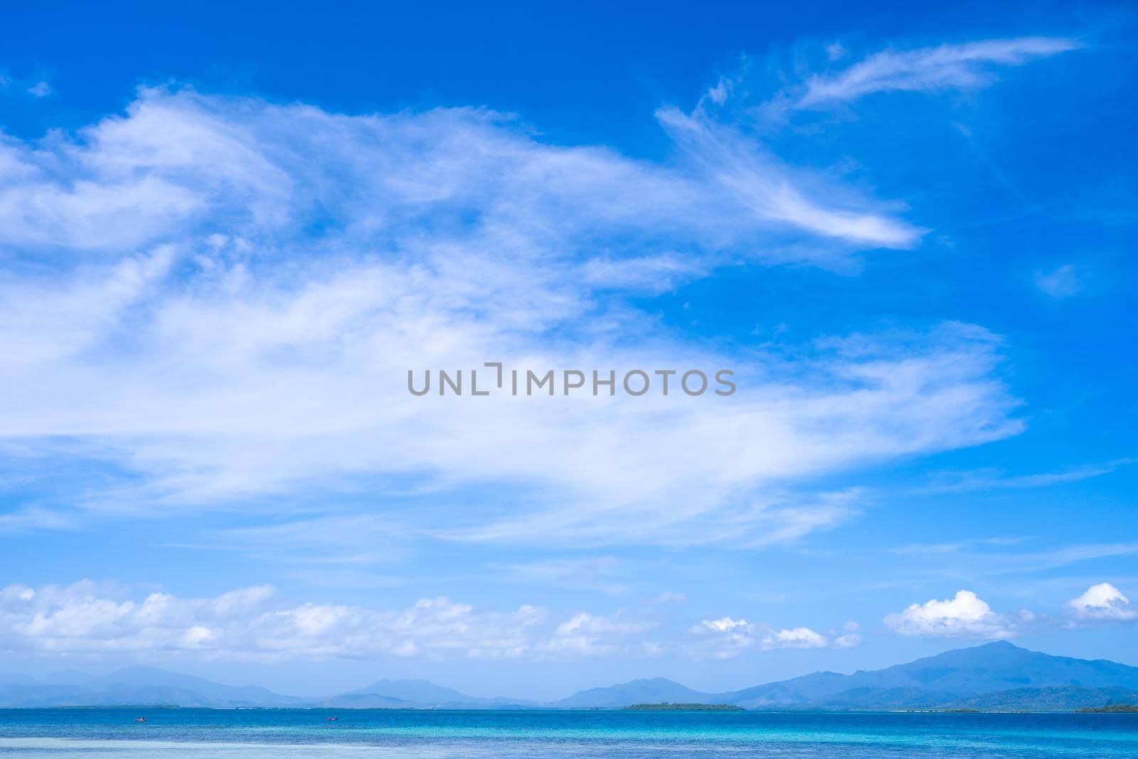 Beautiful ocean scene view isolated with light blue sky background, concept of vacation and sea travel, copy space