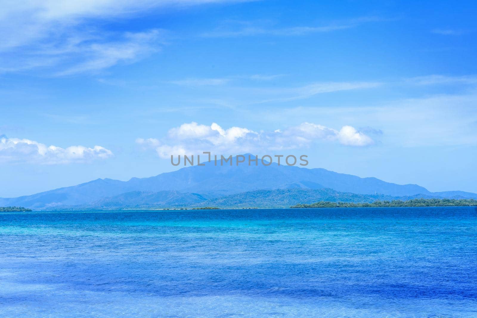 Beautiful ocean scene view isolated with light blue sky background, concept of vacation and sea travel, copy space