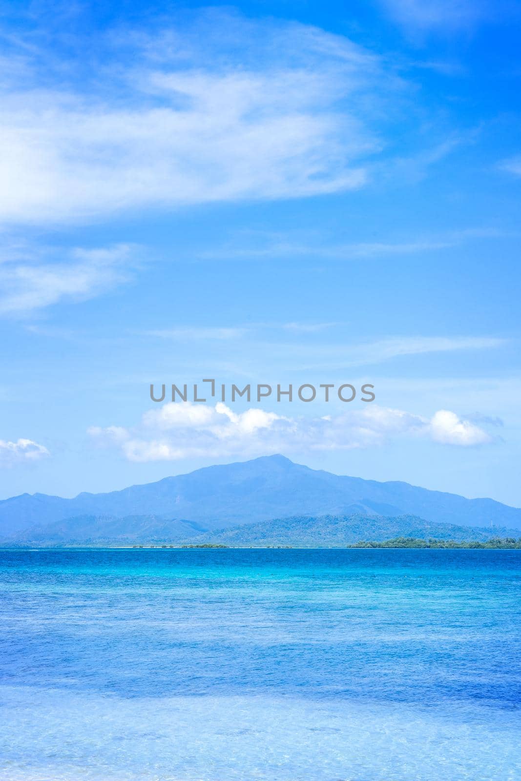 Beautiful ocean scene view isolated with light blue sky background, concept of vacation and sea travel, copy space