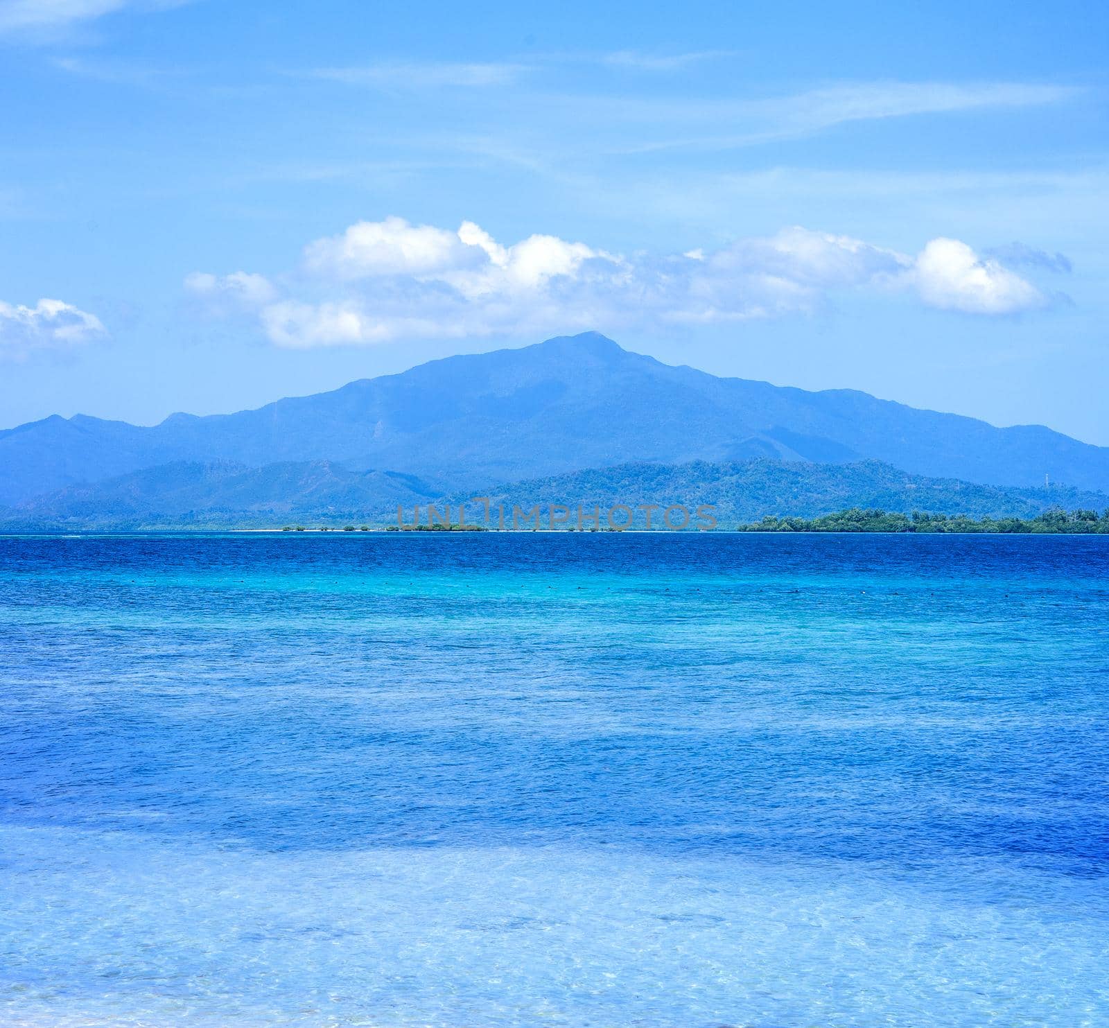 Beautiful ocean scene view isolated with light blue sky background, concept of vacation and sea travel, copy space