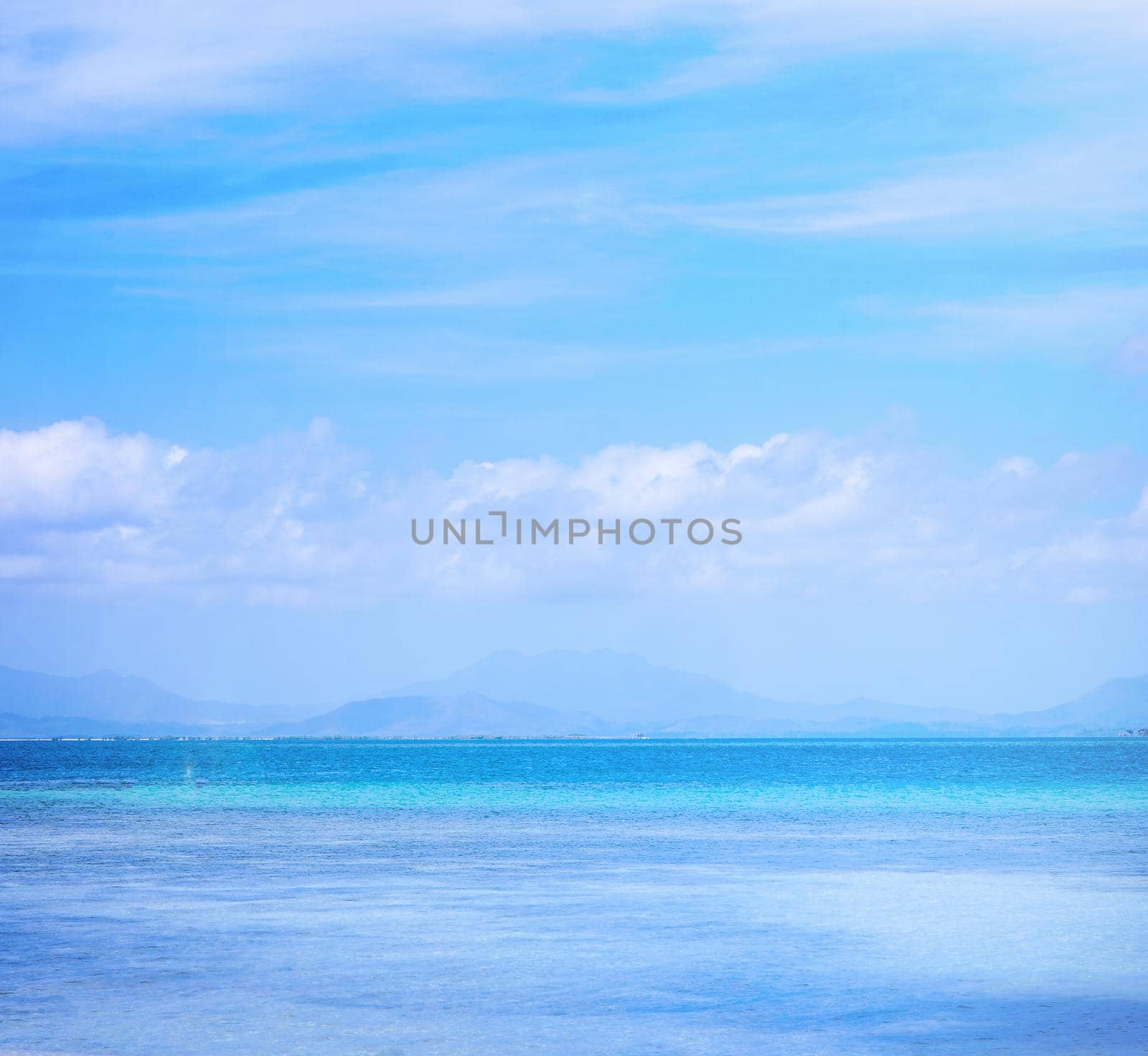 Beautiful ocean scene view isolated with light blue sky background, concept of vacation and sea travel, copy space
