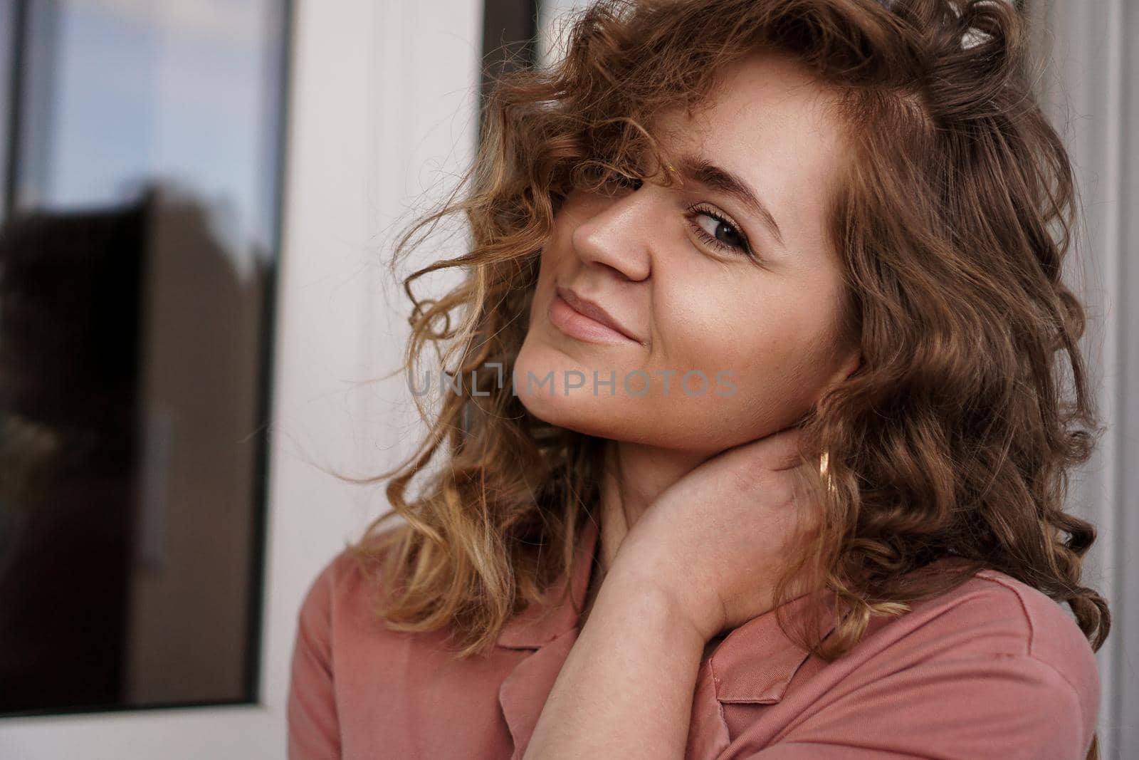 Portrait Of A Pretty Happy Woman with curly hair